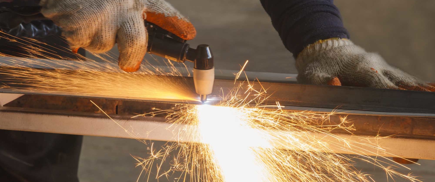 Close up view of welding worker using plasma cutter