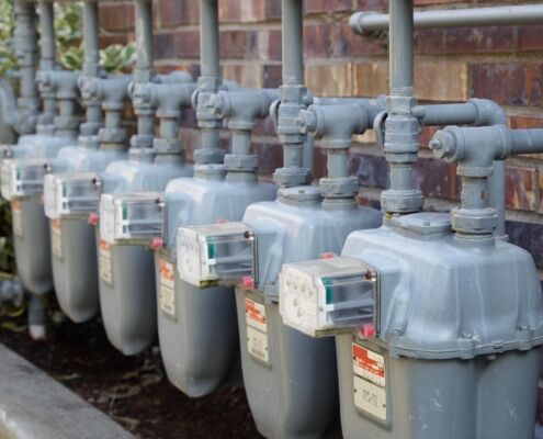Side view of a row of gas meters with full manifolding