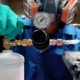 Image of a person calibrating a tank of gas.