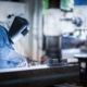 Industrial welder welding fabricated construction in factory
