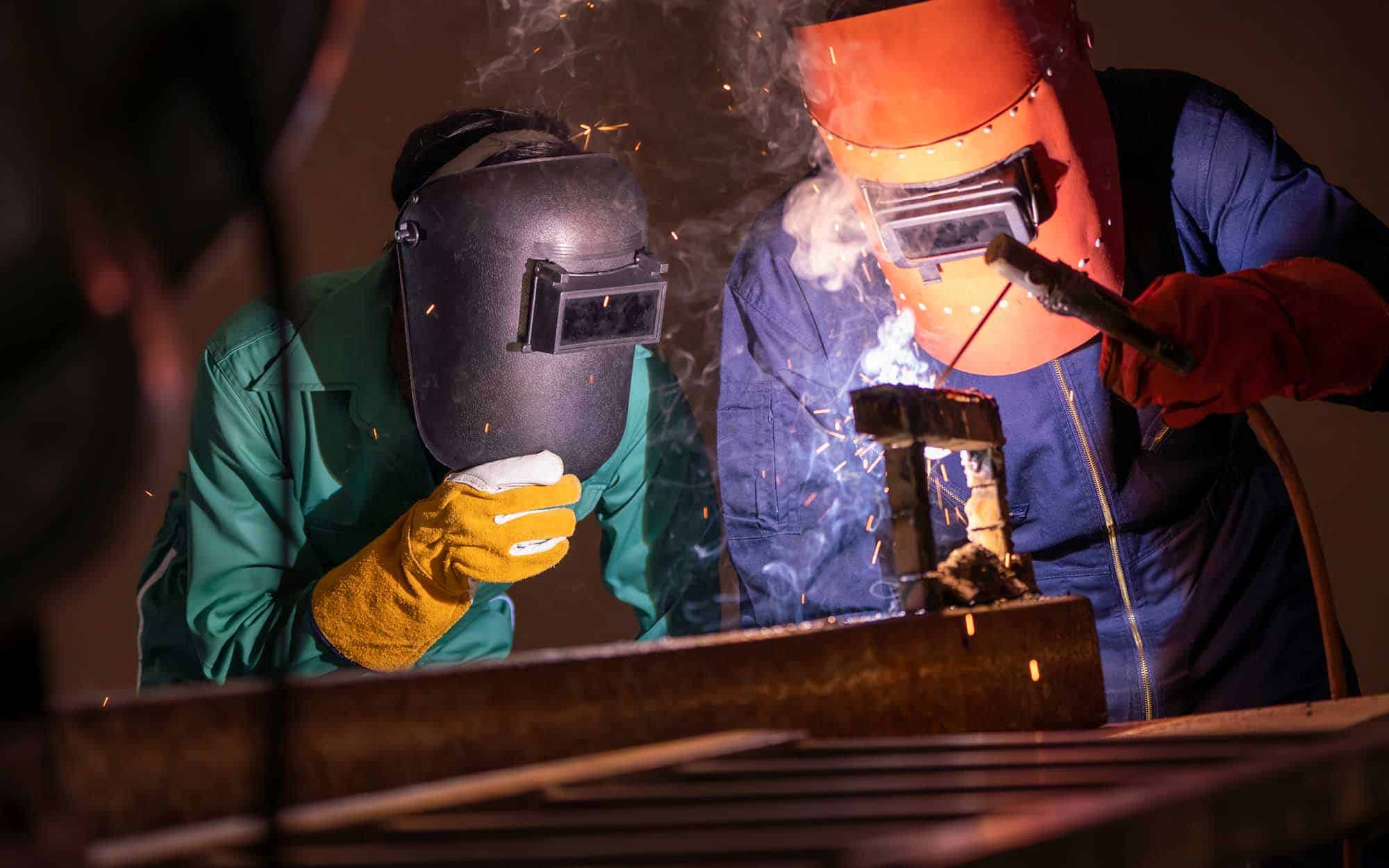 Group of two welders working on metal fabrication