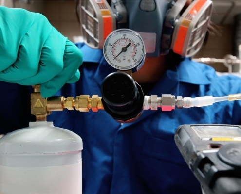 Image of a person calibrating a tank of gas.