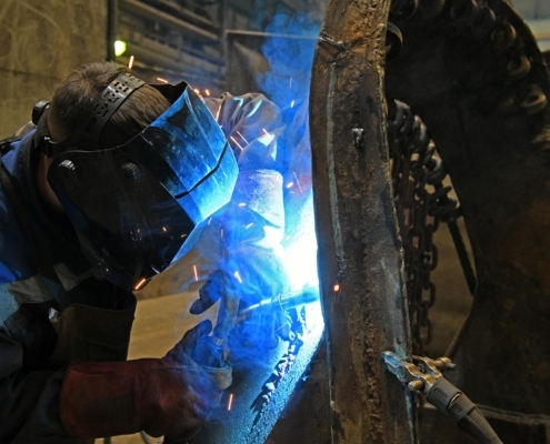 Image of a worker welding on a construction site.