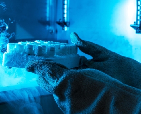Side view of a person in gloves handling dry ice