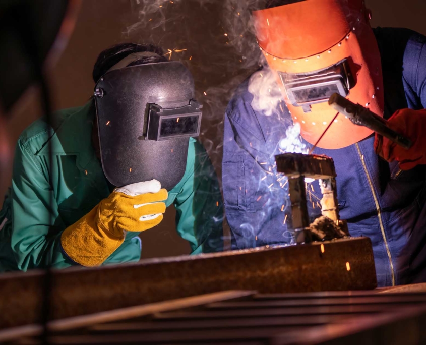 Group of two welders working on metal fabrication