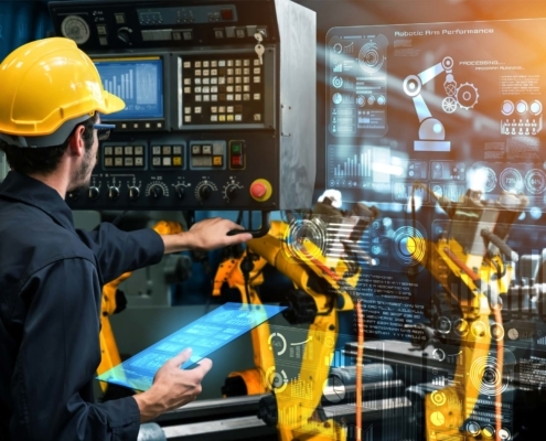 welding operator reviewing welding robotic arm performance on a screen