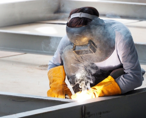 Welding work ,worker with protective welding metal on construction