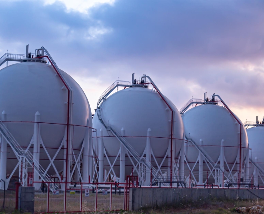 sideview of industrial gas tanks at sunset