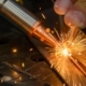 Worker using laser welder on two metal pieces