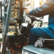 A man on a forklift works in a large warehouse, unloads bags of raw materials
