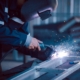 masked engineer using welding equipment