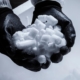 Image of a person handling dry ice with thick rubber gloves